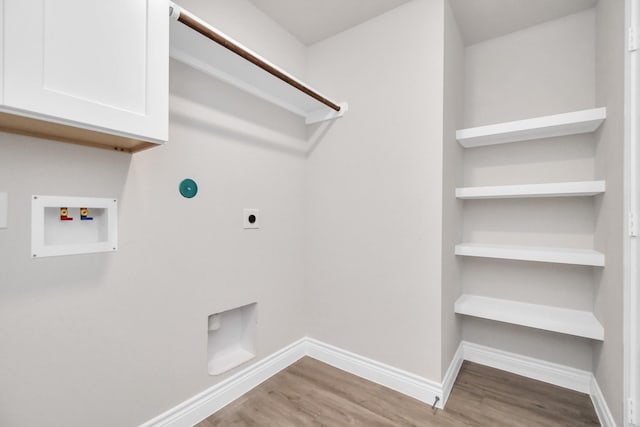 laundry area featuring washer hookup, cabinet space, hookup for an electric dryer, wood finished floors, and baseboards