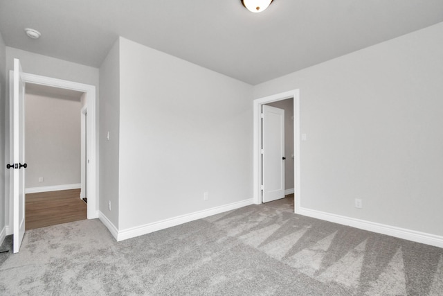 unfurnished bedroom with carpet flooring and baseboards