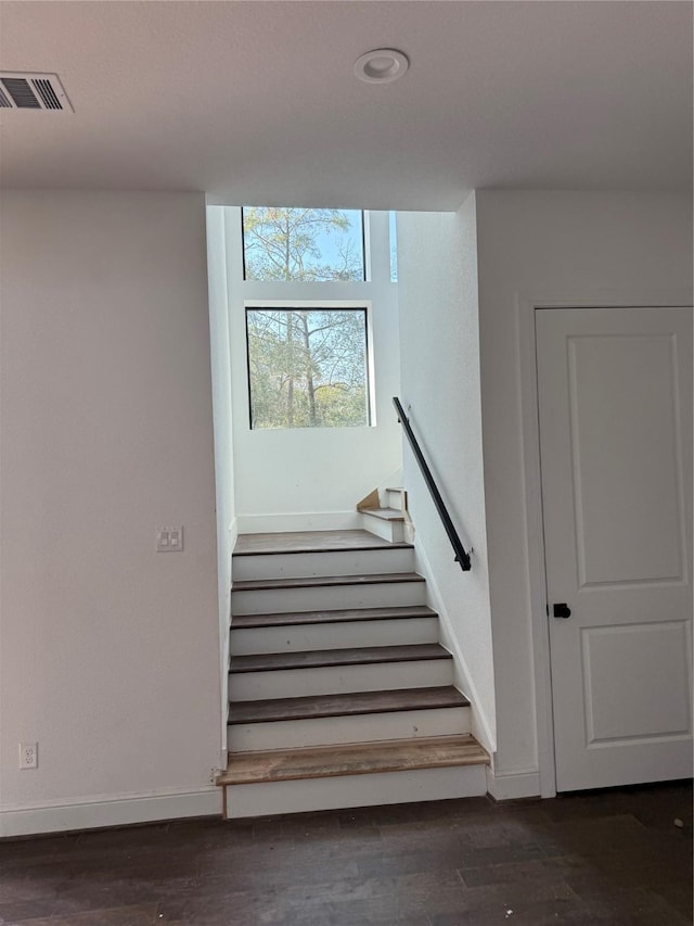 stairway featuring wood-type flooring