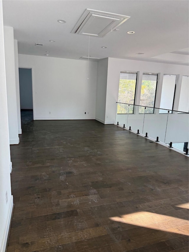 spare room with dark wood-type flooring