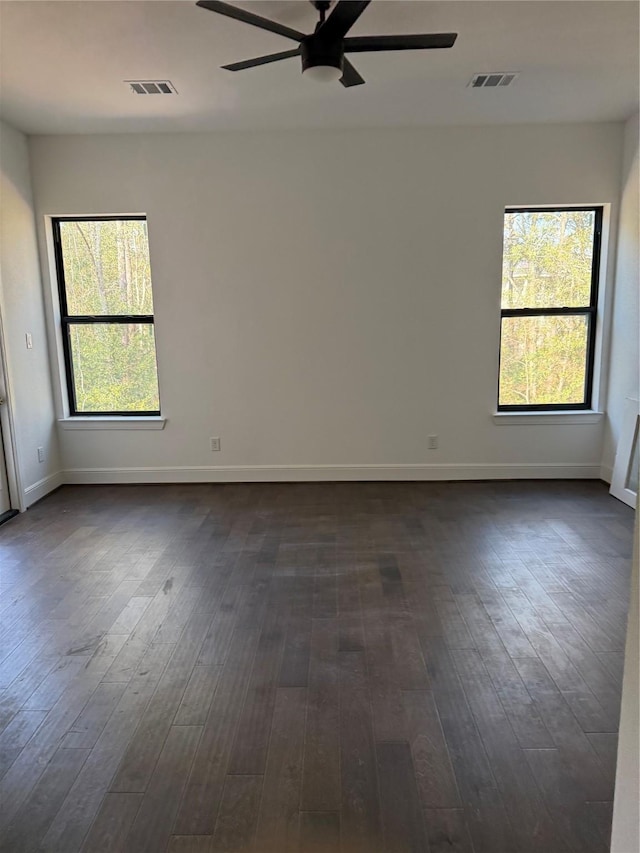 empty room featuring ceiling fan and dark wood-type flooring