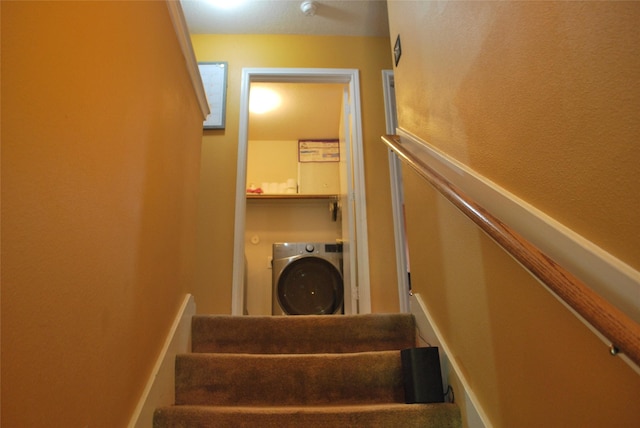 staircase featuring washer / dryer