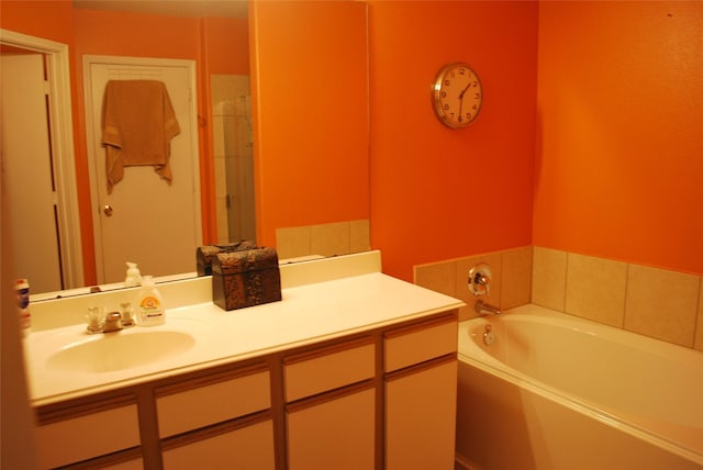 bathroom featuring vanity and a bath