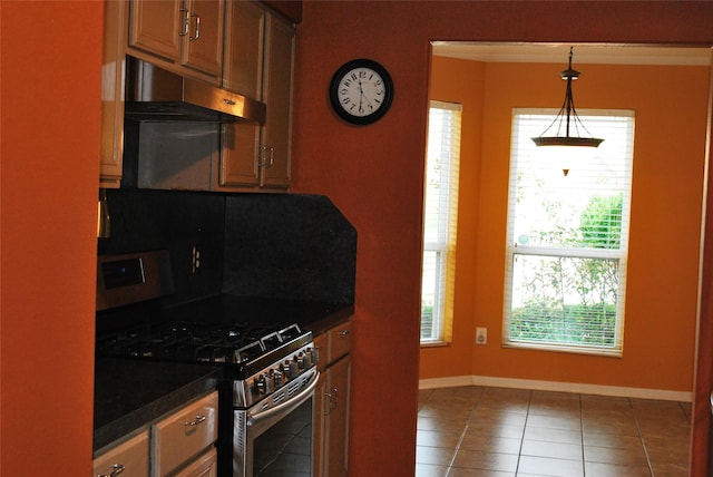 kitchen featuring tile patterned floors, high end stainless steel range, decorative light fixtures, and ventilation hood