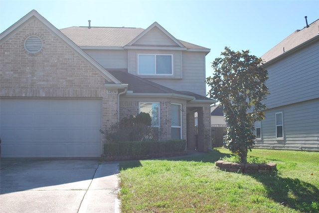 front of property featuring a front lawn and a garage