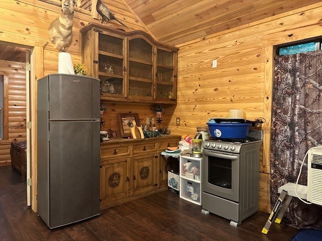 kitchen with vaulted ceiling, wood walls, wooden ceiling, dark hardwood / wood-style flooring, and stainless steel appliances