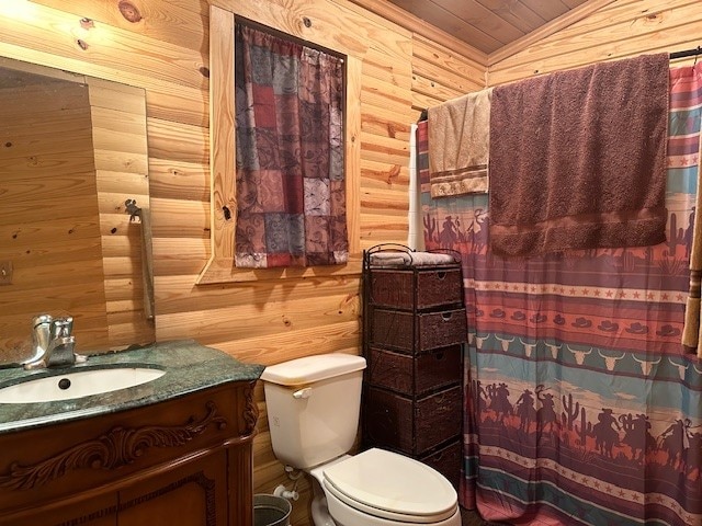 bathroom featuring vanity, walk in shower, toilet, lofted ceiling, and wooden walls