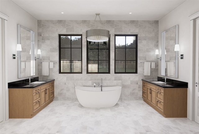 bathroom with vanity, tile walls, a bathing tub, and a wealth of natural light