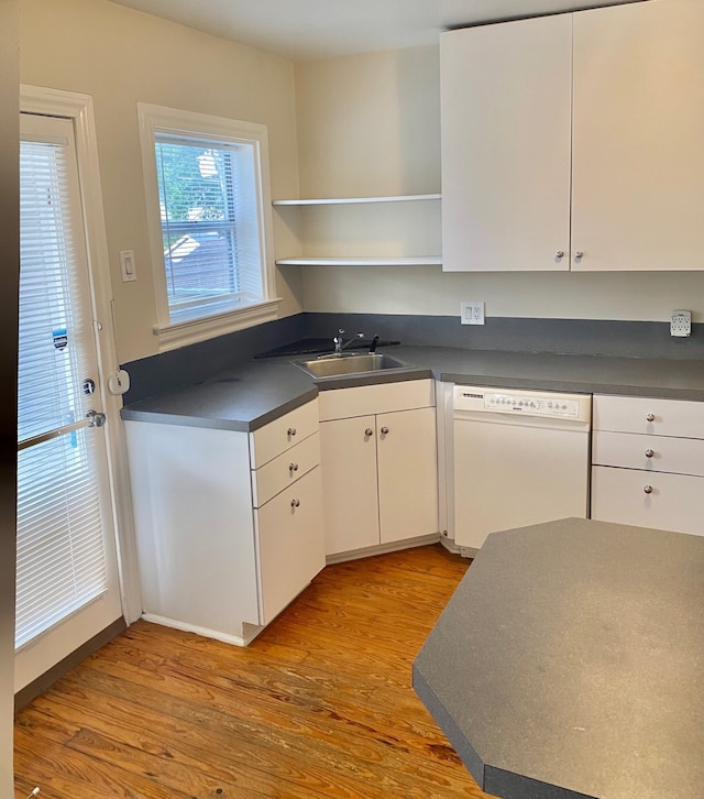 kitchen with dishwasher, sink, light wood-type flooring, and white cabinetry