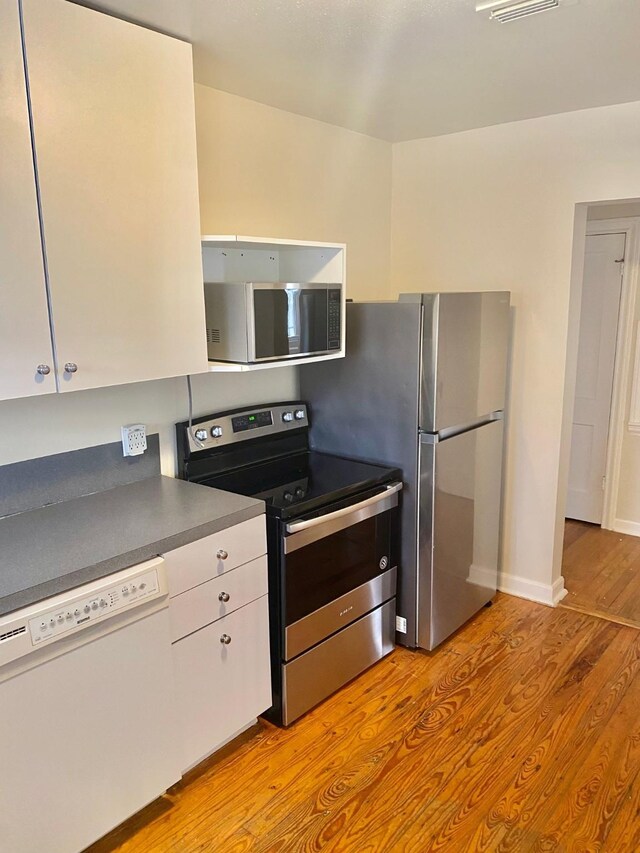 kitchen with stainless steel appliances and light wood-type flooring