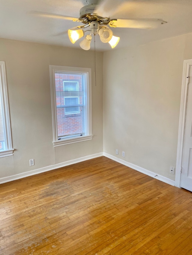 spare room with hardwood / wood-style floors and ceiling fan