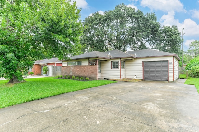 ranch-style house with a garage and a front lawn