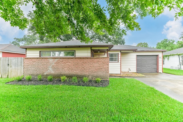 ranch-style house featuring a garage and a front yard