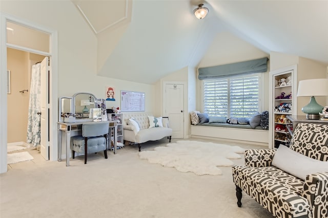 sitting room with lofted ceiling and light colored carpet