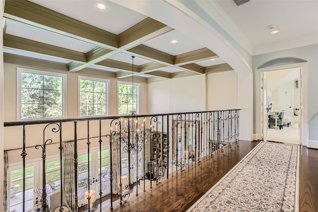 corridor featuring coffered ceiling, crown molding, wood-type flooring, french doors, and beam ceiling