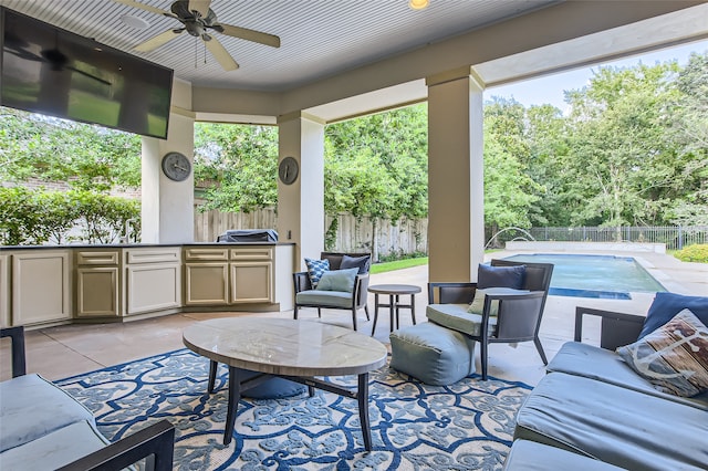 view of patio / terrace with area for grilling, ceiling fan, and a fenced in pool