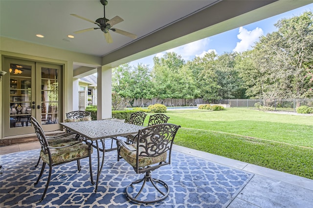25002 Falling Water Estates Ln, Katy, TX 77494 - view of patio / terrace featuring french doors, ceiling fan, outdoor dining space, and view of scattered trees