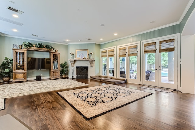 living room with crown molding, hardwood / wood-style flooring, and french doors