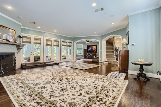 25002 Falling Water Estates Ln, Katy, TX 77494 - living area with arched walkways, crown molding, wood finished floors, a high end fireplace, and stairway