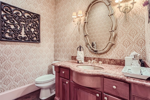 25002 Falling Water Estates Ln, Katy, TX 77494 - half bath featuring wallpapered walls, wood finished floors, toilet, and vanity