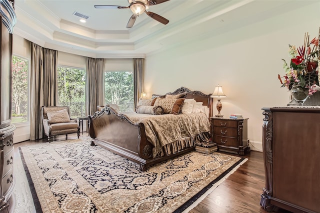 25002 Falling Water Estates Ln, Katy, TX 77494 - bedroom featuring ornamental molding, a tray ceiling, dark wood-style flooring, a ceiling fan, and recessed lighting