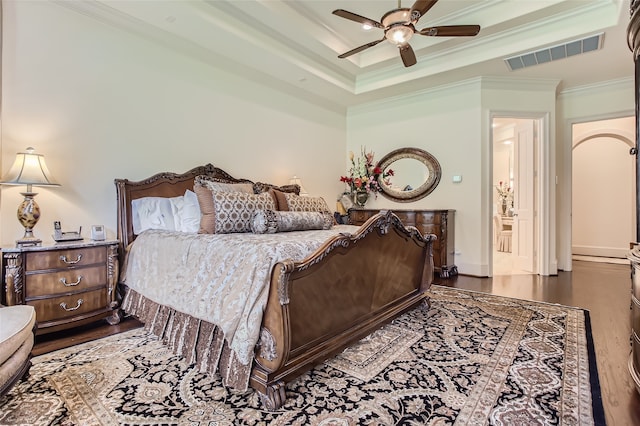 bedroom with crown molding, dark wood-type flooring, and ceiling fan