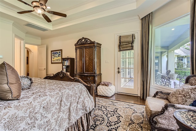 25002 Falling Water Estates Ln, Katy, TX 77494 - bedroom with crown molding, access to exterior, arched walkways, a raised ceiling, and wood finished floors