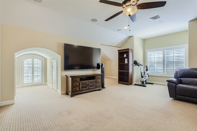 living room featuring carpet, ceiling fan, and vaulted ceiling