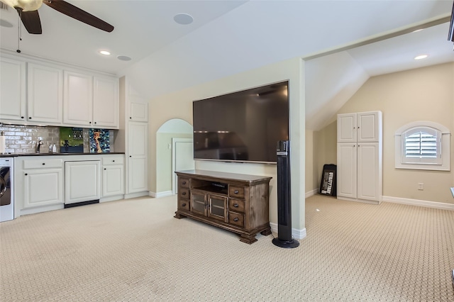 25002 Falling Water Estates Ln, Katy, TX 77494 - living room featuring vaulted ceiling, light colored carpet, a ceiling fan, washer / clothes dryer, and baseboards
