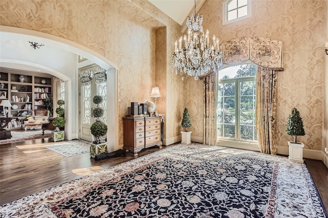 25002 Falling Water Estates Ln, Katy, TX 77494 - entrance foyer featuring wood finished floors, arched walkways, a high ceiling, a chandelier, and baseboards