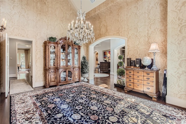 25002 Falling Water Estates Ln, Katy, TX 77494 - entryway featuring arched walkways, a high ceiling, dark wood-type flooring, baseboards, and wallpapered walls