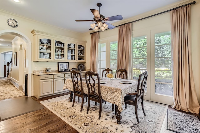 25002 Falling Water Estates Ln, Katy, TX 77494 - dining room with arched walkways, light wood-type flooring, ceiling fan, and crown molding