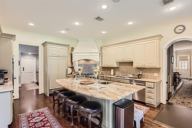 25002 Falling Water Estates Ln, Katy, TX 77494 - kitchen featuring dishwasher, a sink, arched walkways, ornamental molding, and dark wood finished floors