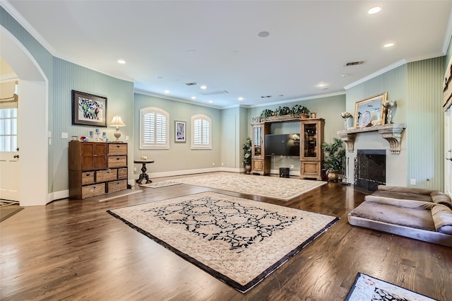 25002 Falling Water Estates Ln, Katy, TX 77494 - living area featuring crown molding, arched walkways, dark wood-type flooring, a fireplace, and recessed lighting