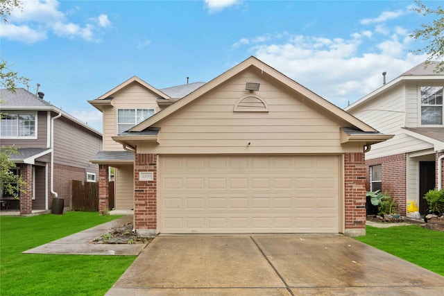 view of front of house with a front yard and a garage