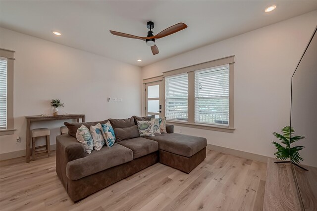 living room with ceiling fan and light hardwood / wood-style floors