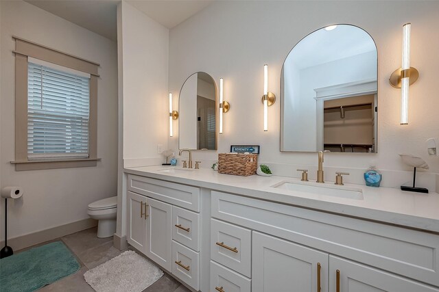 bathroom with vanity, toilet, and tile patterned flooring