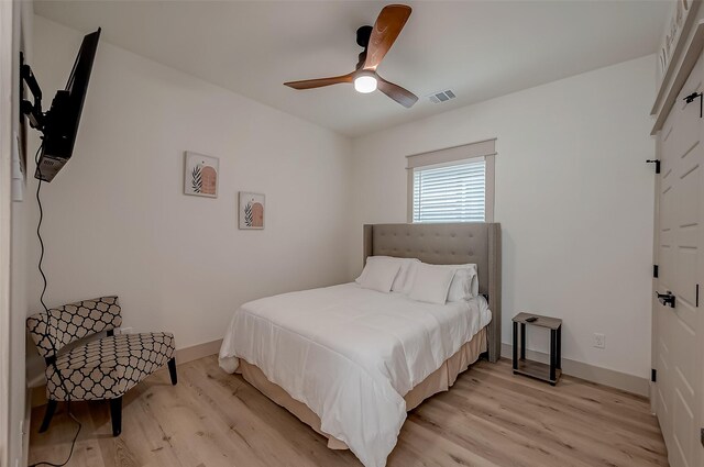 bedroom with light wood-type flooring and ceiling fan