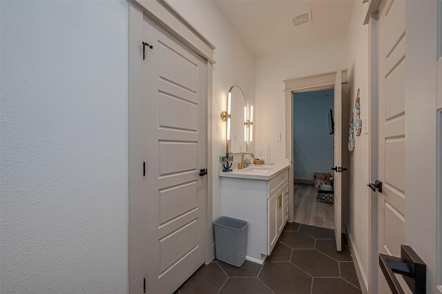 bathroom with tile patterned flooring and vanity