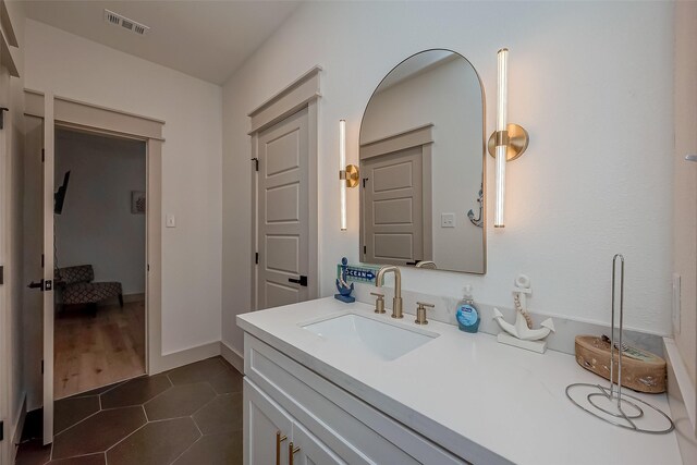 bathroom featuring tile patterned flooring and vanity