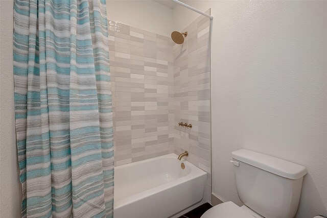 bathroom featuring toilet and shower / bath combo