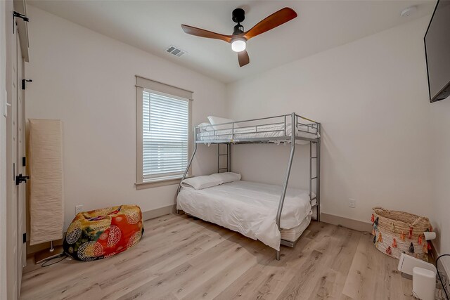 bedroom with ceiling fan and light hardwood / wood-style floors