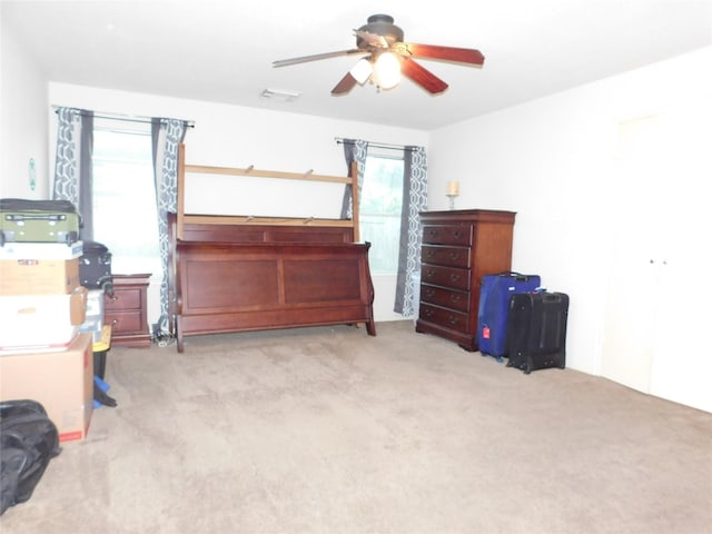 bedroom featuring ceiling fan and light carpet