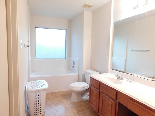 bathroom with toilet, vanity, and a tub to relax in