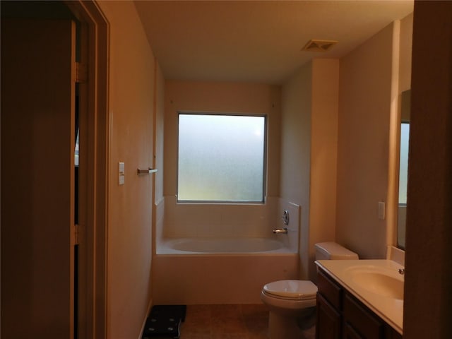 bathroom with vanity, tile patterned flooring, a tub, and toilet