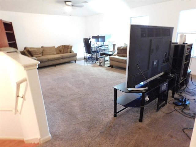 carpeted living room with ceiling fan