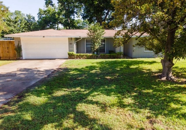 ranch-style home featuring fence, an attached garage, a front lawn, brick siding, and driveway