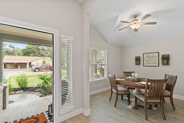 dining area featuring ceiling fan, plenty of natural light, light wood-type flooring, and lofted ceiling