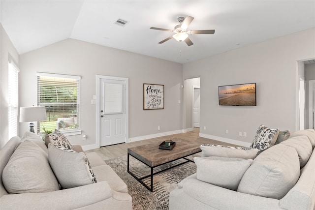 living room with ceiling fan, light wood-type flooring, and lofted ceiling