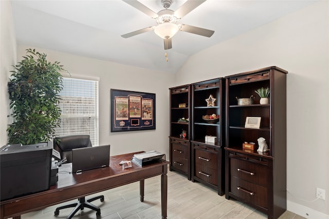 home office featuring light hardwood / wood-style flooring, lofted ceiling, and ceiling fan